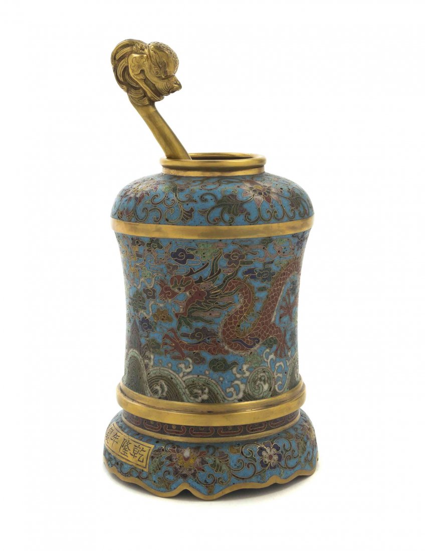 A Chinese Cloisonne Enamel Water Coupe with Ladle,: A Chinese Cloisonne Enamel Water Coupe with Ladle, the waisted cylindrical body depicting a pair of confronting dragons amidst ruyi clouds over jagged mountain peaks with rolling, crested waves, raise