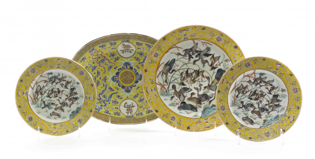 A Group of Four Chinese Polychrome Decorated Ceramic: A Group of Four Chinese Polychrome Decorated Ceramic Dishes, three of circular form depicting ducks within a border of scrolled lotus vines against a yellow ground, with an oval platter having wan and