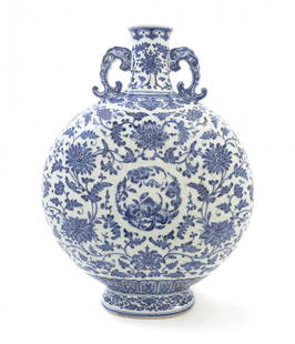 A Chinese Blue and White Porcelain Moon Flask, Height: A Chinese Blue and White Porcelain Moon Flask, having elephant mask double handles issuing ruyi, with scrolled lotus decoration throughout centered by a roundel of peaches and a bat, with Qianlong mar