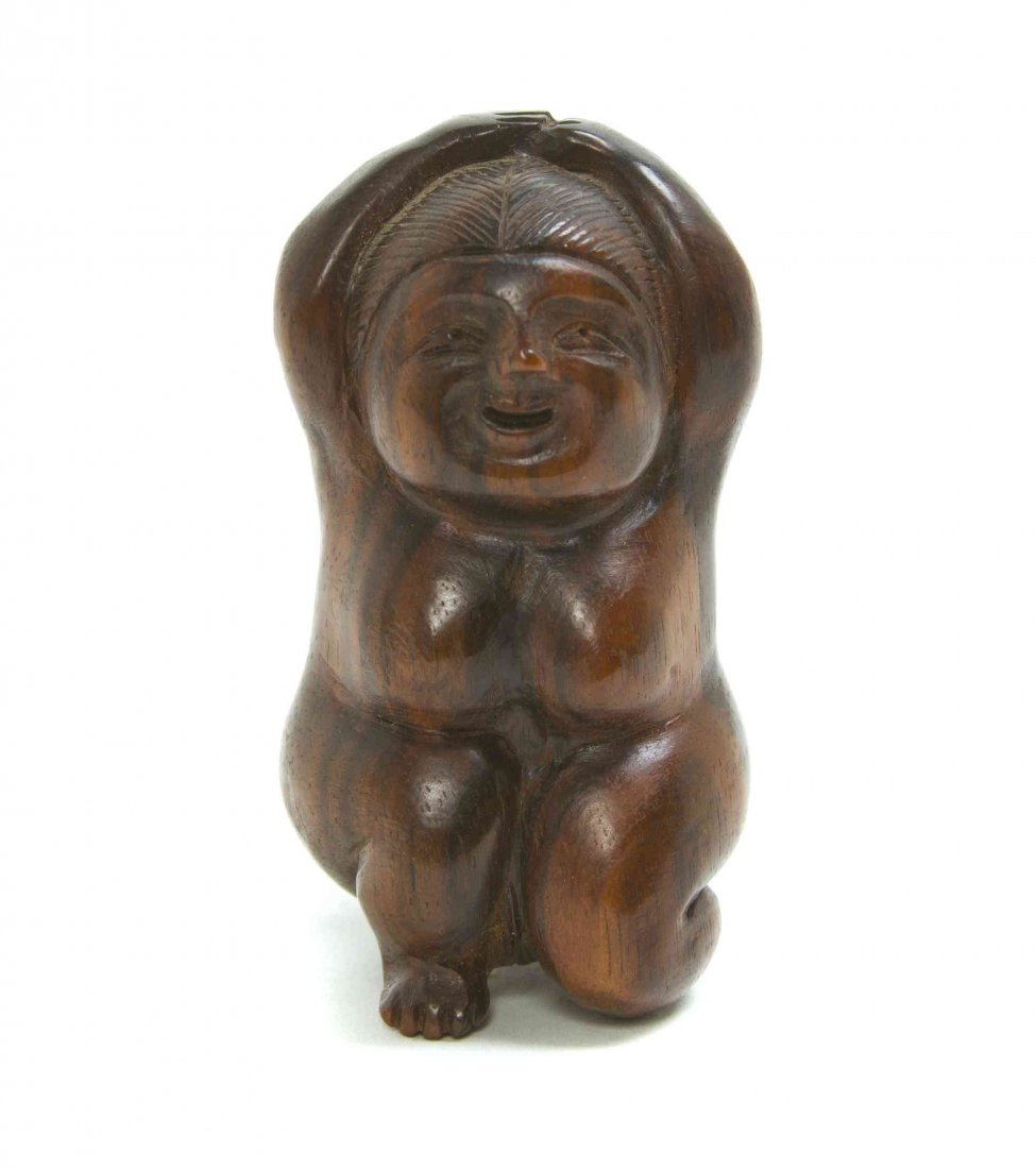 A Carved Ebony Figural Netsuke, Height 2 1/4 inches.: A Carved Ebony Figural Netsuke, depicting a nude okame figure, signed. Height 2 1/4 inches. Property from the Collection of Dr. J. Don Nelson, Fargo, North Dakota Provenance: Purchased circa 1950