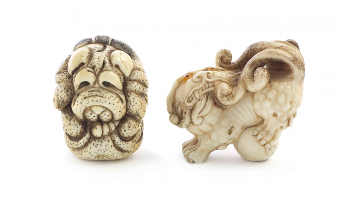 Two Ivory Netsuke, Width of wider 2 1/8 inches.: Two Ivory Netsuke, the first depicting a shishi lion with inlaid eyes, its hind leg grasping the ball below, the other depicting a bulldog, each signed. Width of wider 2 1/8 inches.