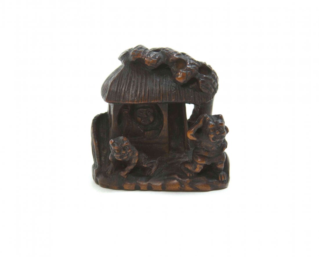 A Carved Wood House Netsuke, Height 1 3/8 inches.: A Carved Wood House Netsuke, with two oni. Height 1 3/8 inches. Property from the Collection of Dr. J. Don Nelson, Fargo, North Dakota Provenance: Purchased circa 1950