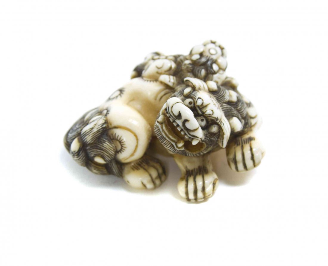 A Carved Ivory Shishi Lion with Pup Netsuke, Width at: A Carved Ivory Shishi Lion with Pup Netsuke, the beasts depicted with finely incised accents to their fur and tails, unsigned. Width at widest 1 7/8 inches. Property from the Collection of Dr. J. Don 