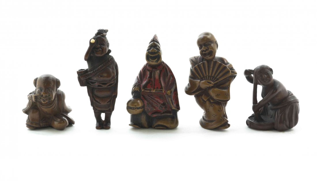 A Group of Five Carved Wood Japanese Netsuke, Height of: A Group of Five Carved Wood Japanese Netsuke, the first depicting a nude beauty washing her hair, the second a laughing entertainer with a folding fan, the third a lacquered example of a laughing robe