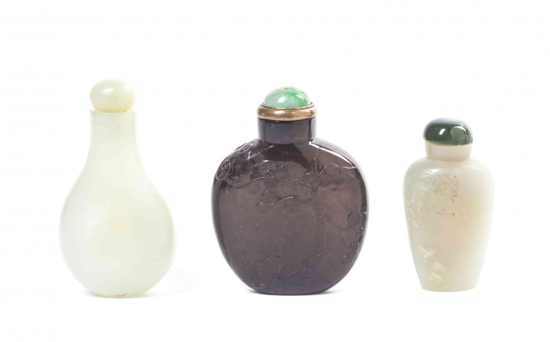 Three Hardstone Snuff Bottles, Height of first 2 1/4: Three Hardstone Snuff Bottles, comprising a dark amethyst example of compressed flask form, relief carved with ducks under a sun, with pine tree, rockery, and bats to the reverse, with a jadeite stopp