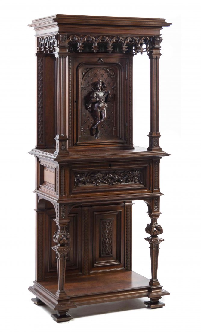 A Renaissance Revival Oak Court Cupboard, Height 73 1/2: A Renaissance Revival Oak Court Cupboard, in two parts, the upper section having a molded cornice above a paneled door carved in relief with a musician and fleurs-de-lis, the lower section with a draw