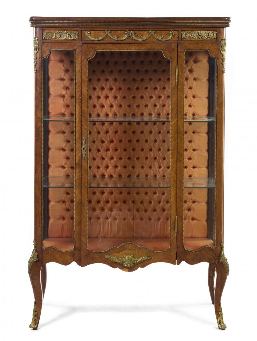 A Louis XV Style Gilt Bronze Mounted Bookmatch Veneered: A Louis XV Style Gilt Bronze Mounted Bookmatch Veneered Vitrine, having a beaded cornice over the glazed door and sides, opening to a shelved, upholstery lined interior above the shaped apron, raised 