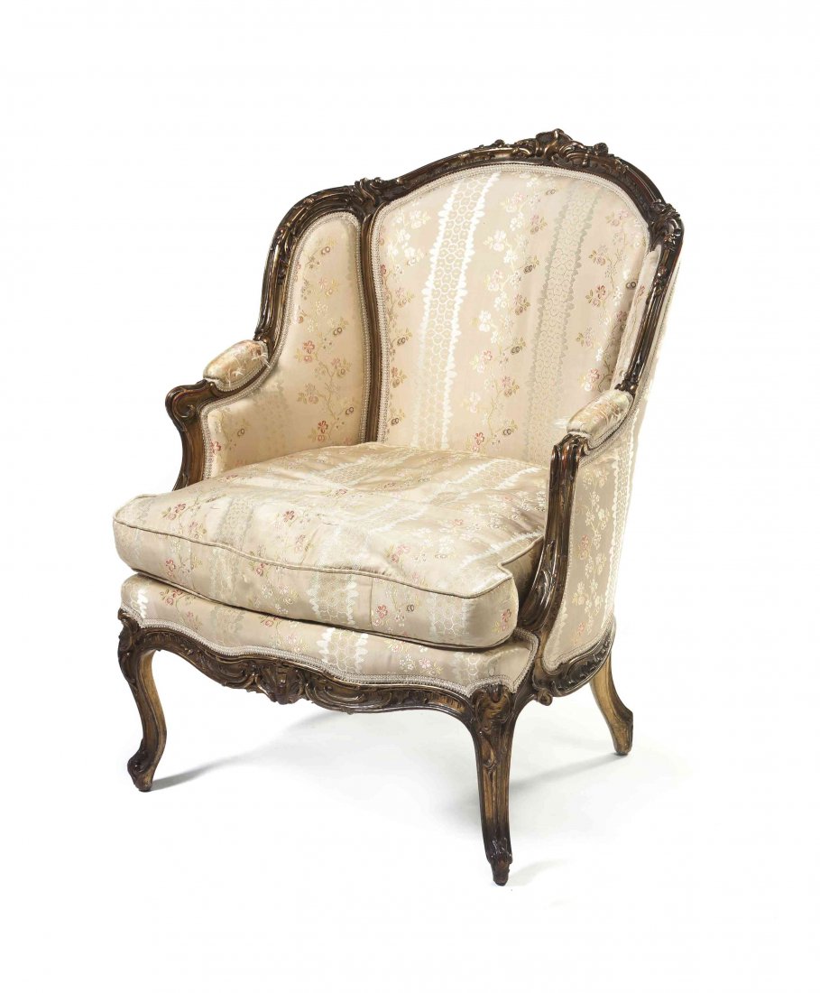 A Louis XV Style Giltwood Bergere a Oreilles, Height 37: A Louis XV Style Giltwood Bergere a Oreilles, having a carved rocaille crest over the frame with similar decoration throughout enclosing an upholstered back, sides, arms and seat, raised on cabriole l
