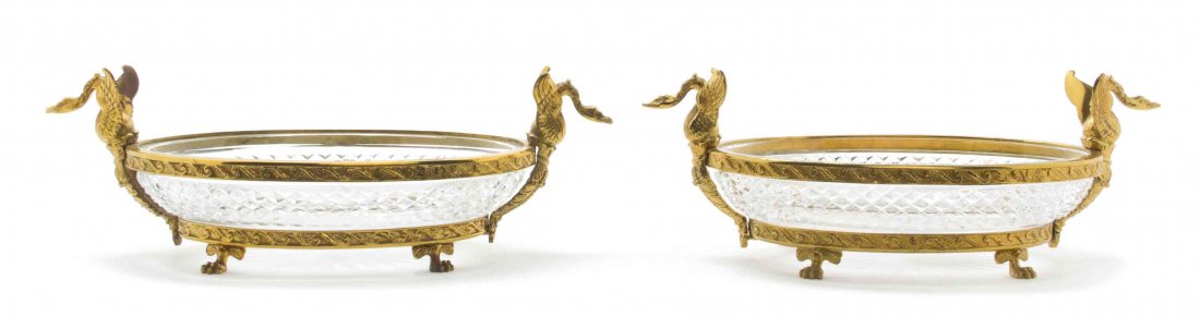 A Pair of Empire Style Gilt Bronze Mounted Cut Glass: A Pair of Empire Style Gilt Bronze Mounted Cut Glass Bowls, each having swan form handles and raised on four paw feet. Width 13 1/2 inches.