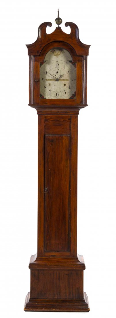 An American Pine Tall Case Clock, Riley Whiting, Height: An American Pine Tall Case Clock, Riley Whiting, the swan neck pediment centered by a brass urn finial over the painted dial with Arabic hours, raised on a straight trunk set on a plinth base. Height