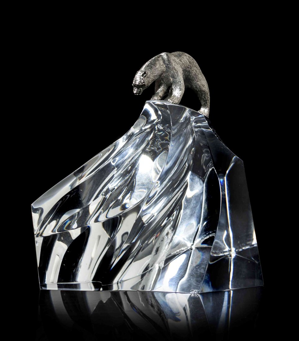 A Steuben Glass and Sterling Silver Sculpture, Height 5: A Steuben Glass and Sterling Silver Sculpture, Ice Bear, designed by James Houston, model 1022, introduced in 1974, modeled as a polar bear standing on a glacier. Height 5 inches. Property from the Co