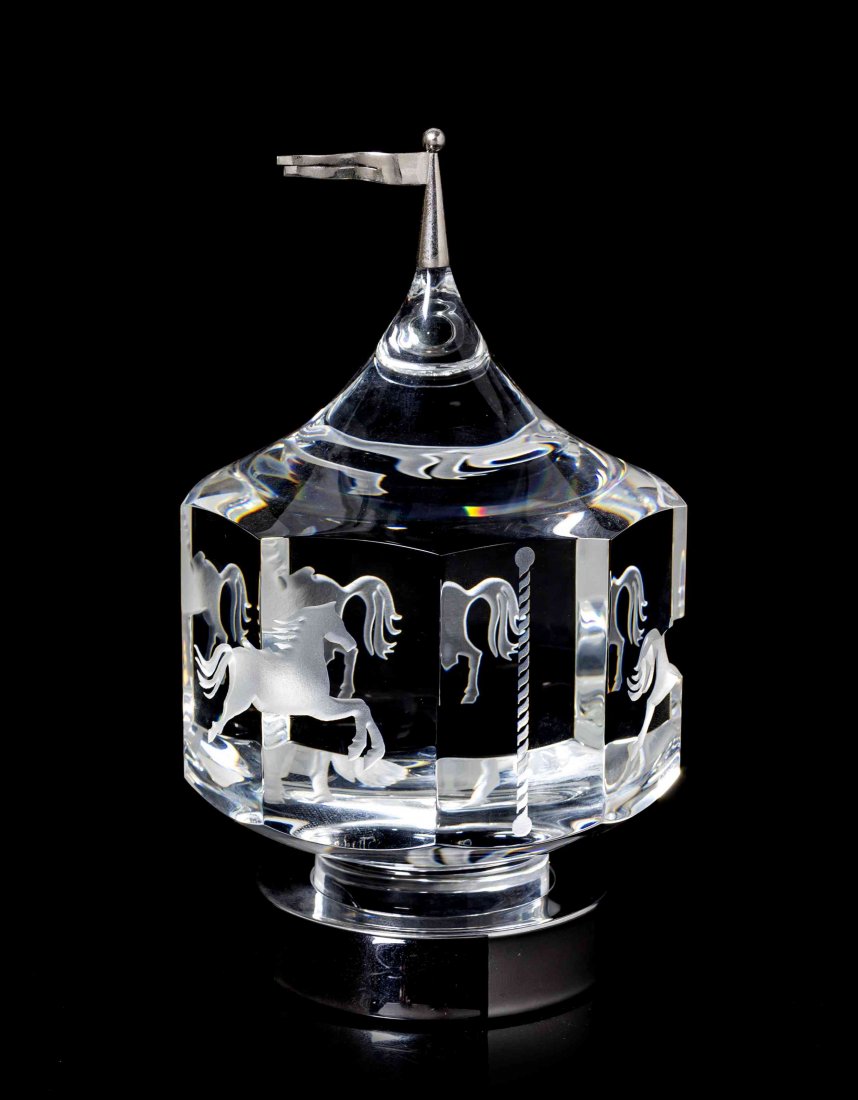 A Steuben Glass Sculpture, Height overall 7 1/4 inches.: A Steuben Glass Sculpture, Carousel, designed by Peter Aldridge and Jane Osborn-Smith, model 1985, introduced in 1985, of hexagonal form with horse decoration. Height overall 7 1/4 inches. Property fr