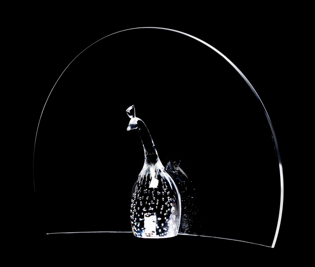 A Steuben Glass Sculpture, Height 10 1/4 inches.: A Steuben Glass Sculpture, Peacock, designed by Joel Smith, the stylized bird with controlled internal air bubble decoration. Height 10 1/4 inches. Property from the Collection of Paul Mavros and Davi