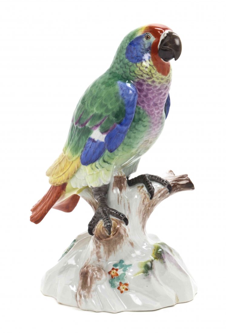 A Meissen Porcelain Ornithological Figure, Height 10: A Meissen Porcelain Ornithological Figure, depicting a parrot seated on a naturalistic base, having polychrome decoration throughout, having scored crossed swords mark in underglaze blue, further inci