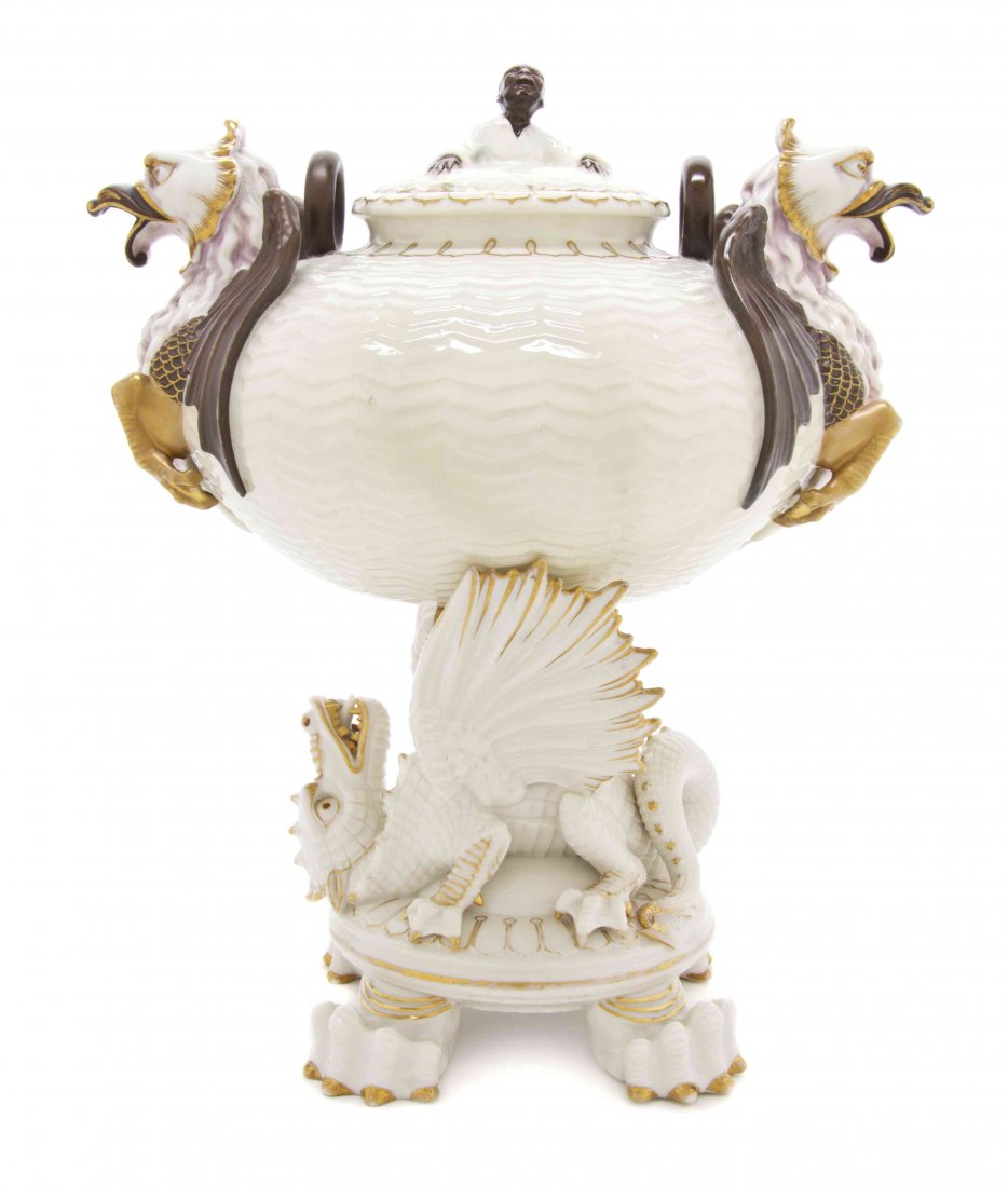 A Belleek Chinese Tea Urn, Height overall 13 inches.: A Belleek Chinese Tea Urn, 1863-1890, the lid having a figural finial, the body with opposing dragon spouts, raised on a dragon form stand with four reptile feet, with first Belleek black mark and mol
