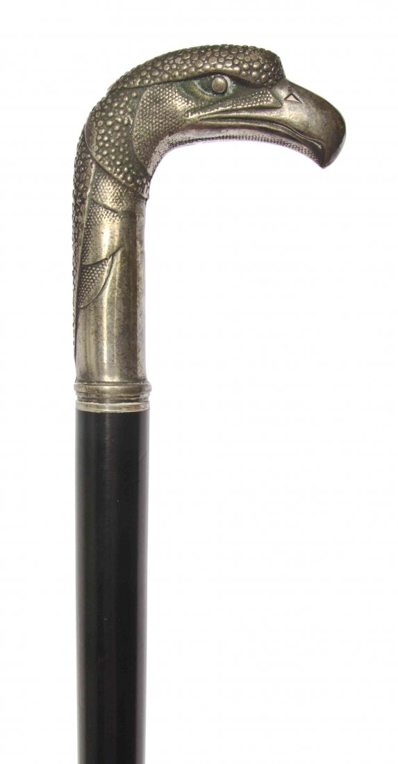 A Silvered Metal Sword Cane, Length of handle 4 x: A Silvered Metal Sword Cane, having an eagle shaped handle, raise on an ebony shaft. Length of handle 4 x length overall 36 1/2 inches. Property from the R&M Collection, Chicago, Illinois