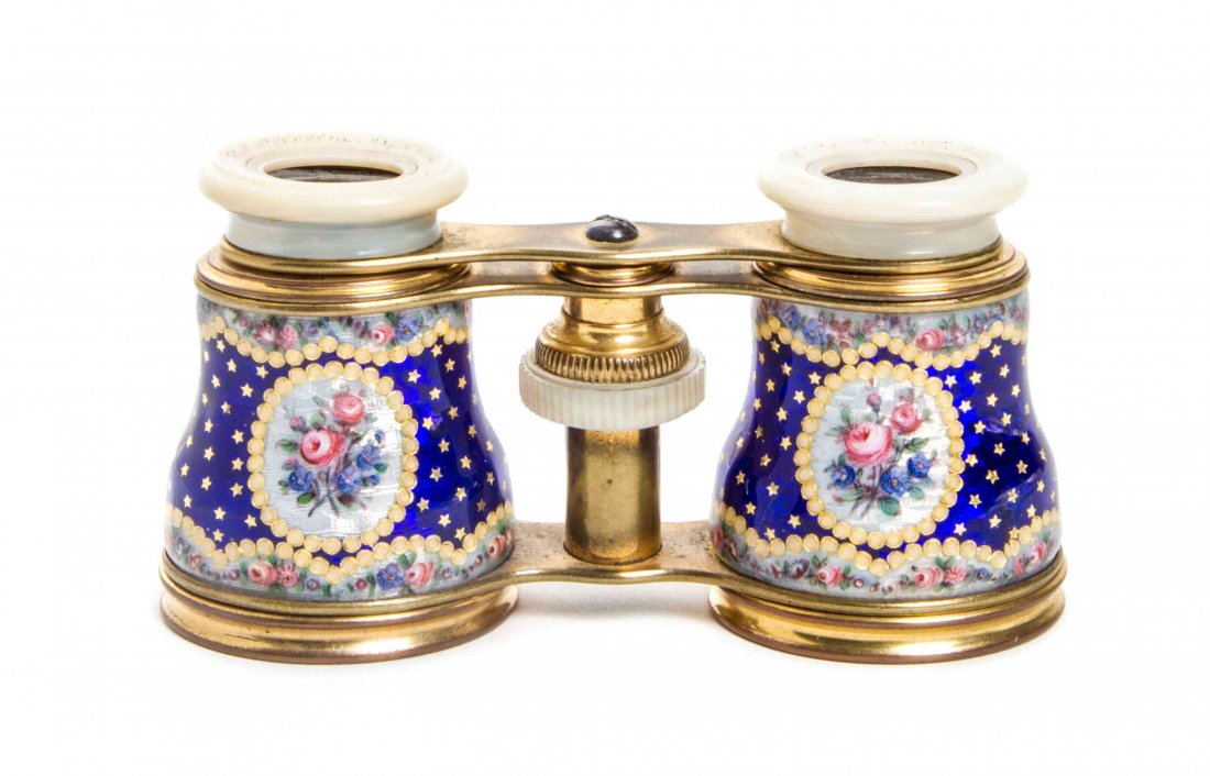 A Pair of French Enameled Opera Glasses, Width 4 1/4: A Pair of French Enameled Opera Glasses, the cylinders with polychrome floral sprays on a cobalt field, having mother-of-pearl eyepieces and a brass frame. Width 4 1/4 inches. Provenance: Property fro