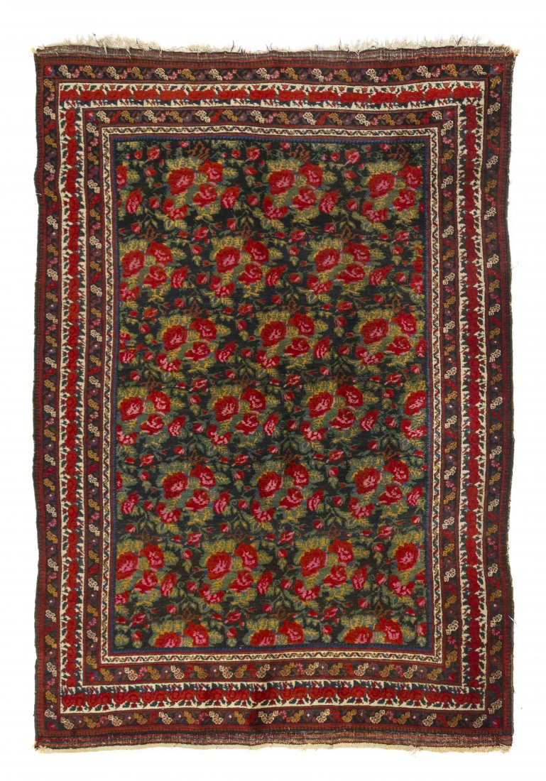 A Shiraz Wool Rug, 4 feet 4 inches x 6 feet 2 inches.: A Shiraz Wool Rug, having allover rose decoration on a black reserve within multiple floral borders. 4 feet 4 inches x 6 feet 2 inches.