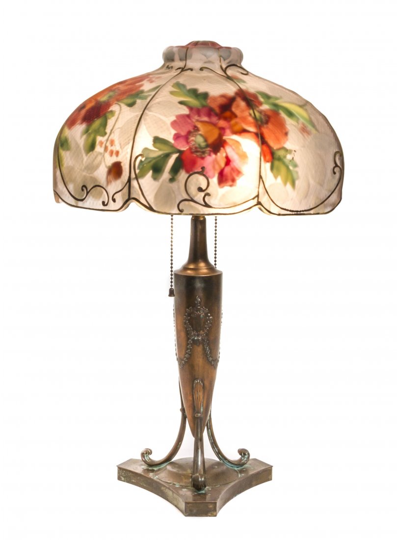 A Pairpoint Reverse Painted Glass Table Lamp, Diameter: A Pairpoint Reverse Painted Glass Table Lamp, the domed octagonal shade painted with flowers and gilt highlights, raised on a baluster form base, marked Pairpoint Mfg Co B3014. Diameter of shade 21 x 