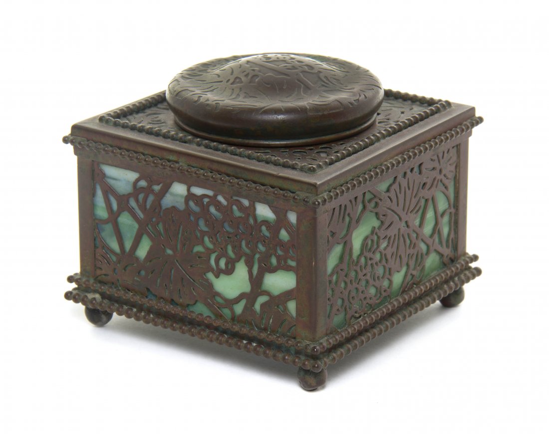 A Tiffany Studios Patinated Bronze Inkwell, Width 4 1/8: A Tiffany Studios Patinated Bronze Inkwell, in the Pine Needle pattern, of square form, stamped Tiffany Studios New York and numbered 844. Width 4 1/8 inches.