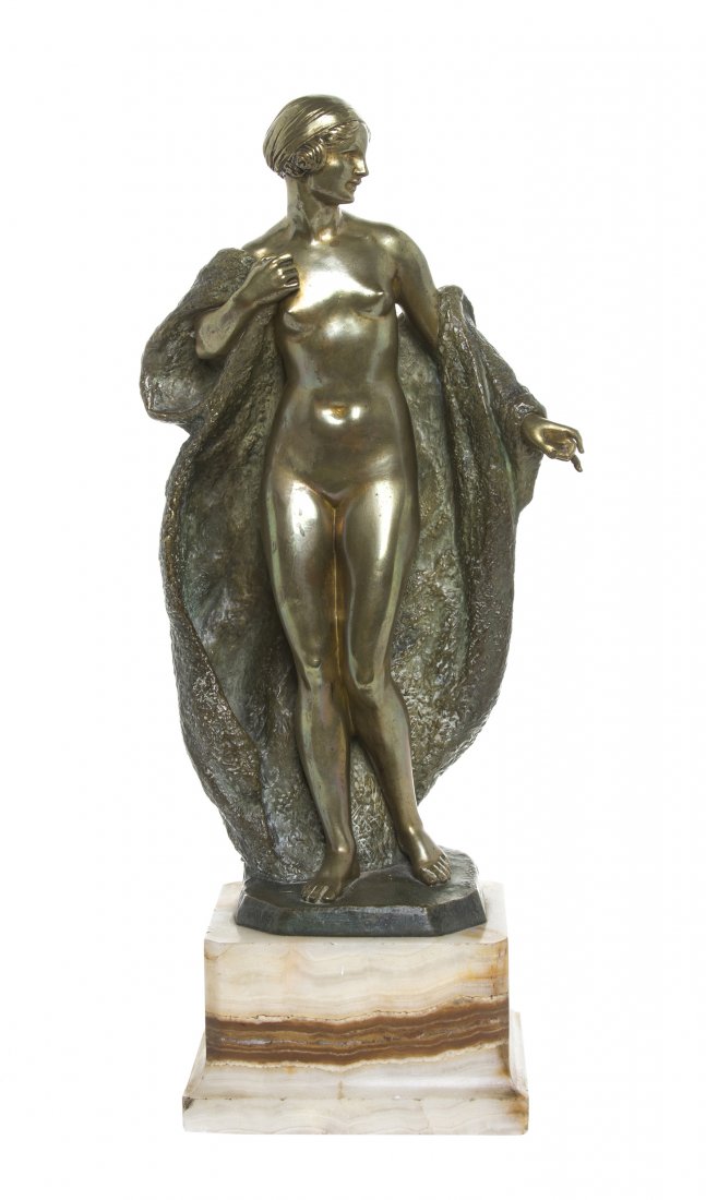 A French Bronze Figure, Joe Descomps (1869-1952),: A French Bronze Figure, Joe Descomps (1869-1952), depicting a nude Art Deco maiden with an open draped coat, signed Joe Descomps, raised on a square onyx base, marked Made in France. Height overall 17
