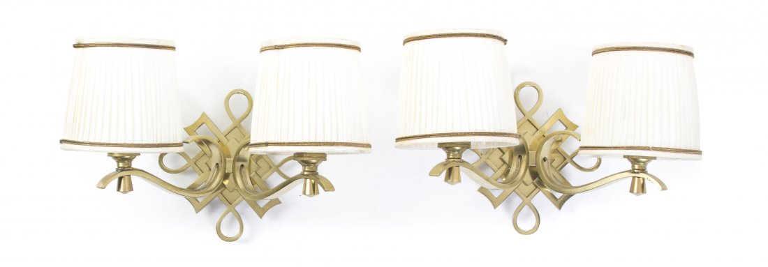 A Pair of Jules Leleu Gilt Bronze Two-Light Sconces,: A Pair of Jules Leleu Gilt Bronze Two-Light Sconces, (French, 1883-1961), each having interlaced backplates, issuing the scrolling candle arms, unsigned. Width 8 1/2 inches.