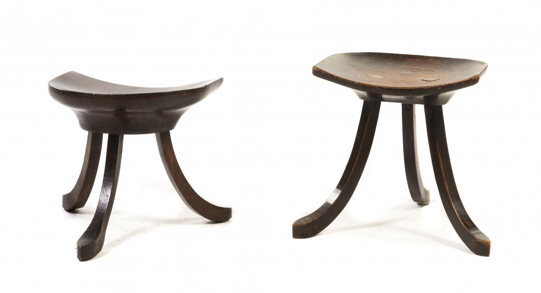 A Near Pair of English Oak Thebes Stools, Height of: A Near Pair of English Oak Thebes Stools, one by Liberty & Co., each having a demilune concave seat, raised on three out swept legs. Height of taller 14 1/4 inches.