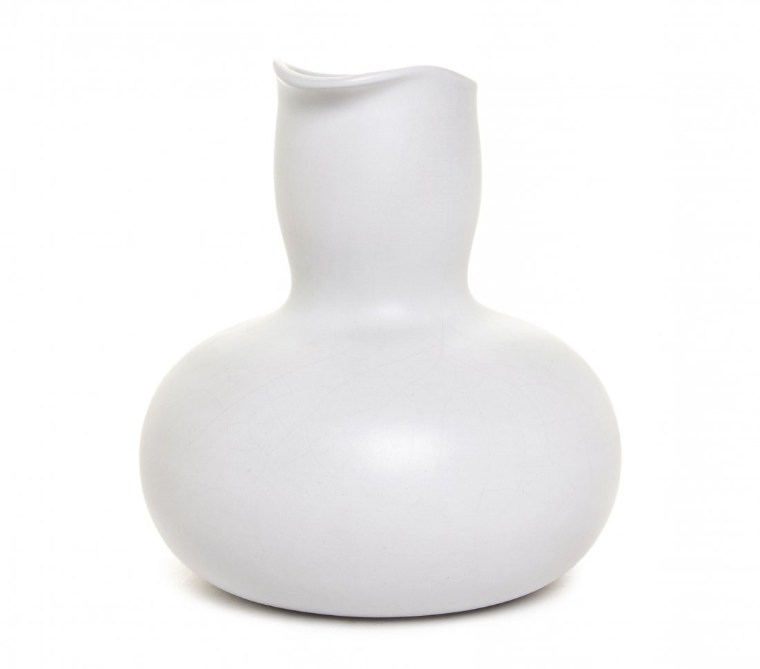 An American Ceramic Carafe, Eva Zeisel (1906-2011) for: An American Ceramic Carafe, Eva Zeisel (1906-2011) for Bret Bortner Design, having a shaped cylindrical neck ending in a bulbous base, with a white matte glaze, signed Eva to base. Height 7 1/4 inches