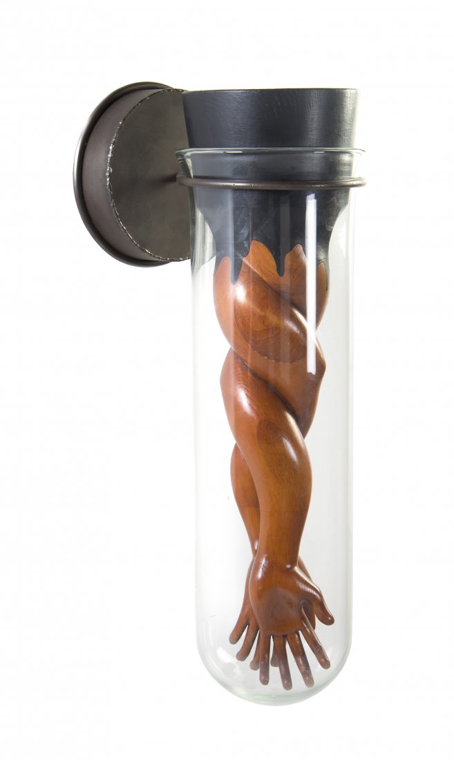 An American Carved Wood, Glass and Steel Sculpture, Ed: An American Carved Wood, Glass and Steel Sculpture, Ed Wicklander (b. 1952), depicting two intertwined arms within a beaker. Height 27 inches.