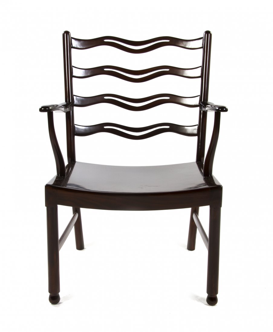 An Ole Wanscher Mahogany Lounge Chair, (Danish,: An Ole Wanscher Mahogany Lounge Chair, (Danish, 1903-1985), having a pierced ladder back over a plank seat, raised on tubular legs ending in spherical feet joined by stretchers. Height 33 5/8 inches. 