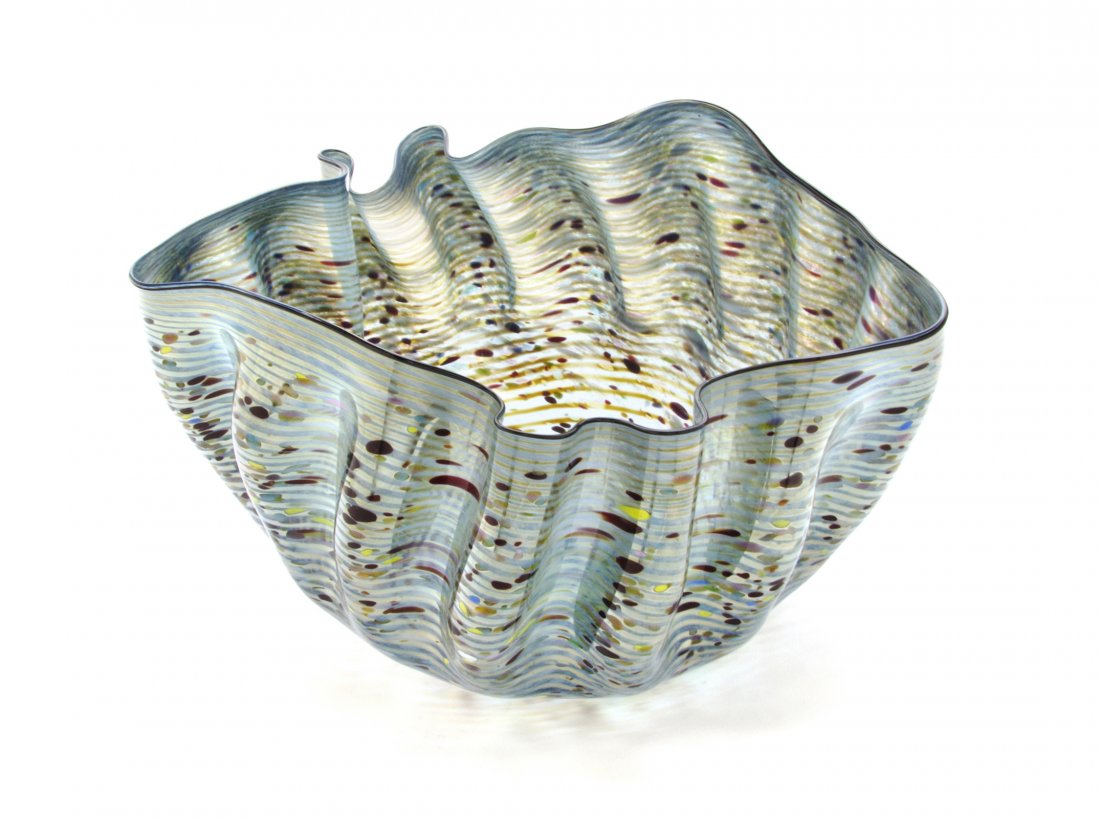An American Studio Glass Sculpture, Dale Chihuly (b.: An American Studio Glass Sculpture, Dale Chihuly (b. 1941), 1983, Macchia, of undulated tapering form with a black lip wrap and a blue ground with mottled polychrome decoration, signed and dated 1983.