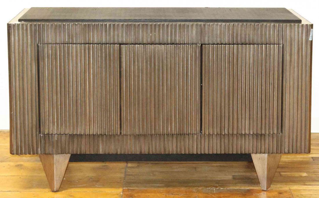 An Art Deco Style Silvered Console Cabinet with Faux: An Art Deco Style Silvered Console Cabinet with Faux Python Top, the rectangular top over the serrated case set with three doors opening to void interiors, raised on tapering legs. Height 35 x width 5