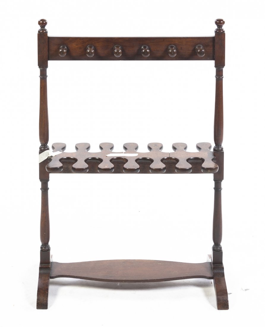 A Georgian Style Mahogany Boot Stand, Height 36 1/4 x: A Georgian Style Mahogany Boot Stand, set with twelve opposing crop hooks, raised on twin supports, joined by a single stretcher. Height 36 1/4 x width 24 inches.