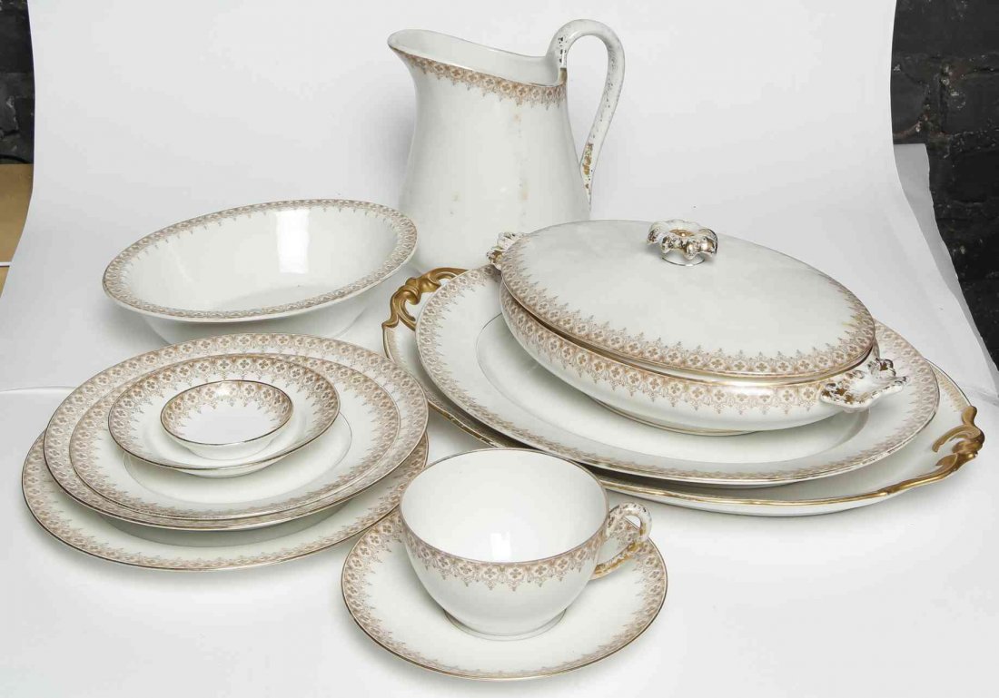 A Limoges Porcelain Partial Dinner Service, Diameter of: A Limoges Porcelain Partial Dinner Service, comprising 10 dinner plates, 9 soup bowls, 2 serving platters, 10 butter plates, 9 fruit bowls, a covered vegetable dish, 5 dessert plates, 4 coffee cups, 5