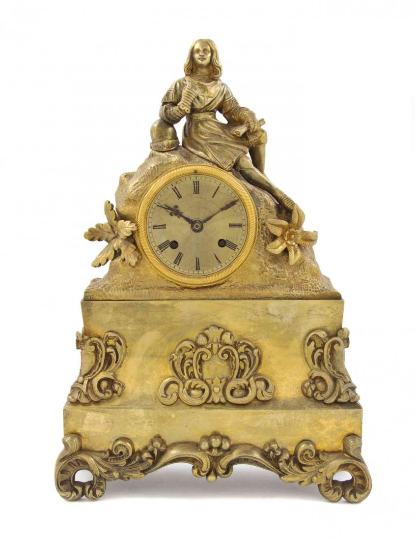A French Gilt Bronze Figural Mantel Clock, Height 14: A French Gilt Bronze Figural Mantel Clock, cast as a recumbent Christopher Columbus with a helmet and map, above the circular dial with Roman hours, having time and strike movement. Height 14 1/2 inch