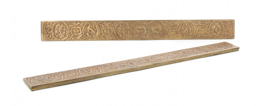 A Pair of Tiffany Studios Dore Bronze Blotter Ends,: A Pair of Tiffany Studios Dore Bronze Blotter Ends, in the Zodiac pattern, stamped Tiffany Studios, New York, 988. Length 19 1/4 inches.