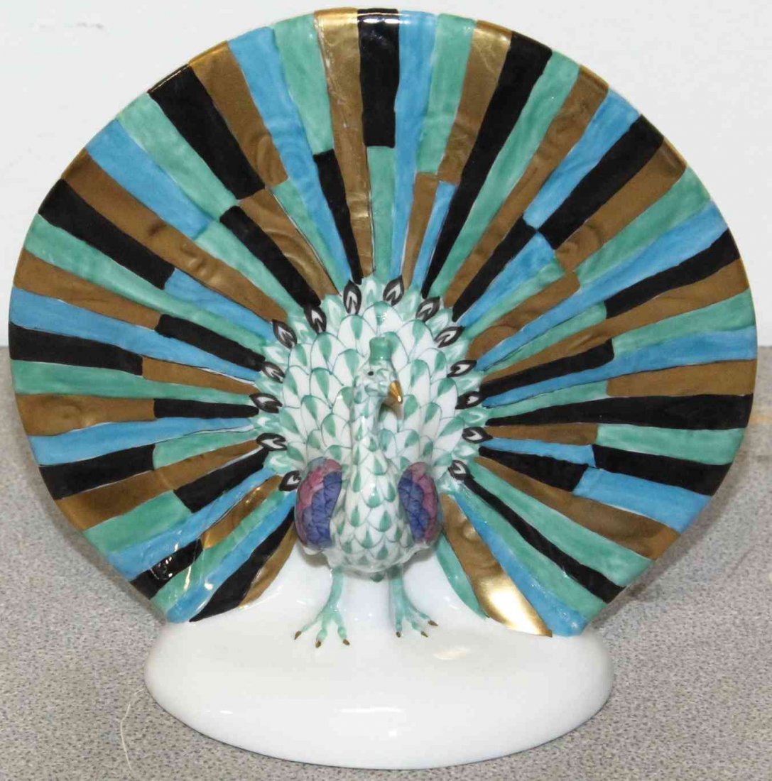 A Herend Porcelain Peacock, Height 4 2/3 inches.: A Herend Porcelain Peacock, with gilt highlights and fishnet decoration throughout. Height 4 2/3 inches. Property from the Estate of Louis M. and Linda M. Byron, Tucson, Arizona