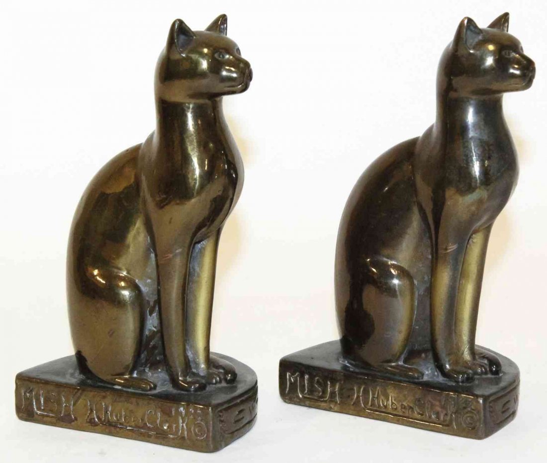 Two Egyptian Revival Book Ends, H. Huber Clark, Height: Two Egyptian Revival Book Ends, H. Huber Clark, each in the form of a seated cat. Height 7 3/4 inches. Property from the Estate of Louis M. and Linda M. Byron, Tucson, Arizona