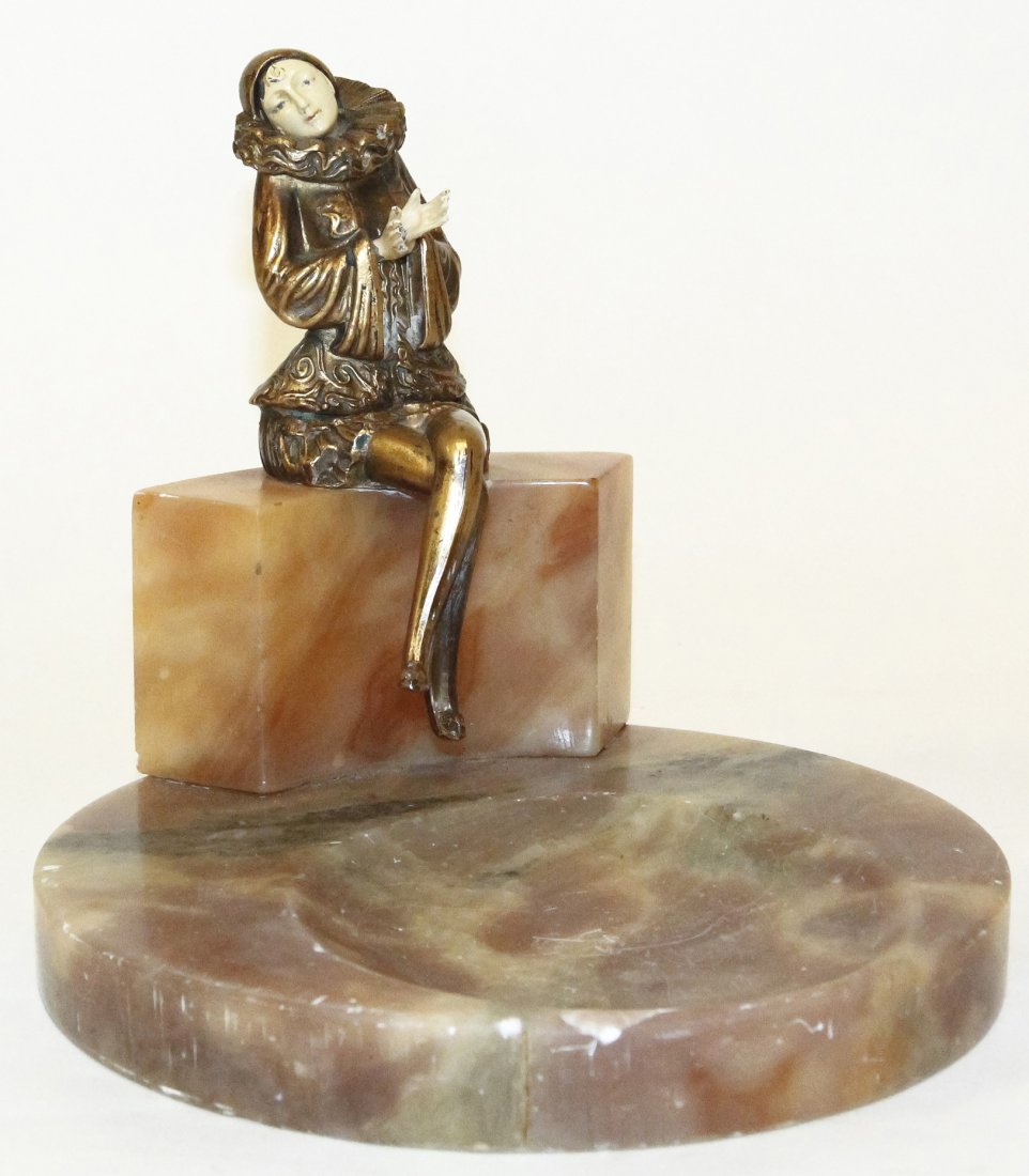 An Art Deco Style Figural Ash Receiver, Height 7: An Art Deco Style Figural Ash Receiver, the gilt metal figure sitting on a rectangular plinth over the circular base. Height 7 inches. Property from the Estate of Louis M. and Linda M. Byron, Tucson, 