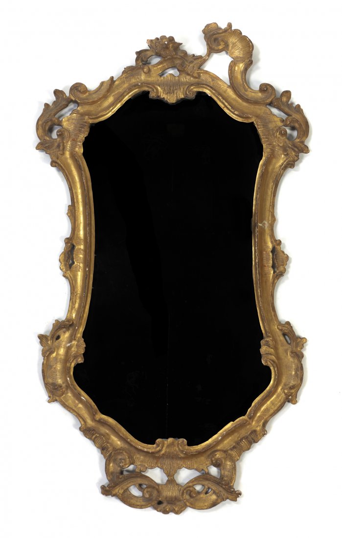 An Italian Giltwood Mirror, Height 33 inches.: An Italian Giltwood Mirror, of cartouche form, having foliate scroll and shell decoration throughout. Height 33 inches. Property from the Collection of Marion P. Church, Chicago, Illinois