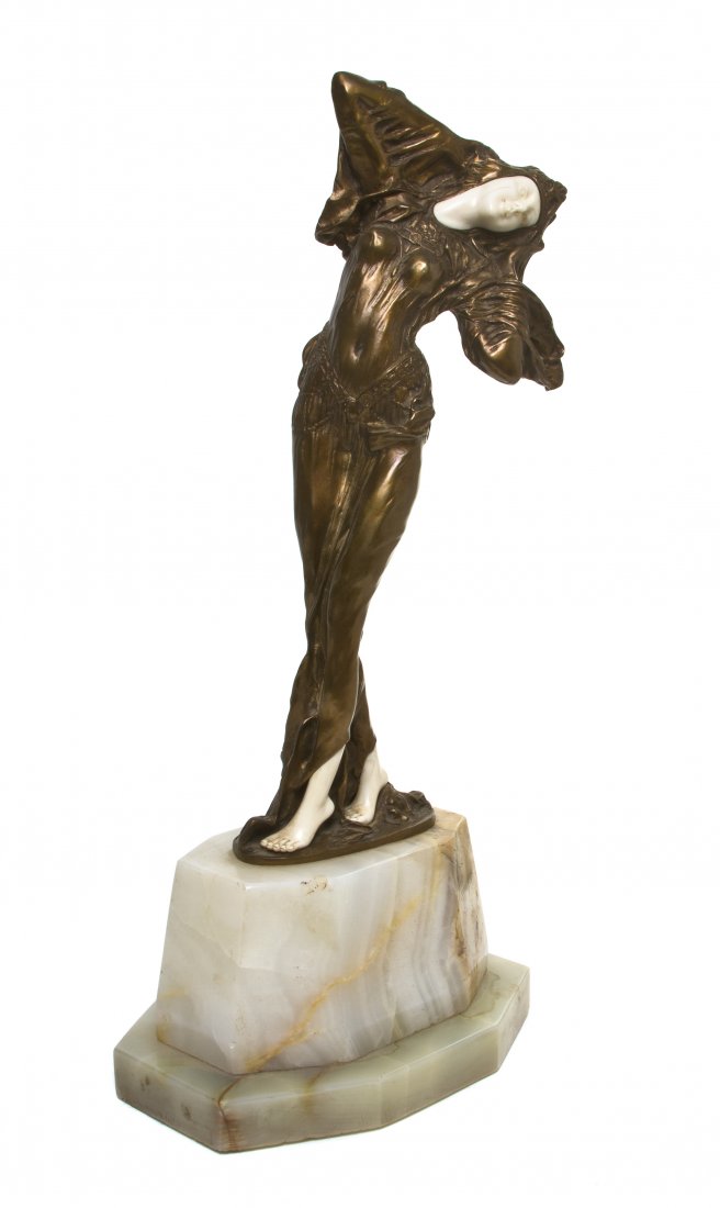 A French Bronze and Ivory Figure, after Demetre H.: A French Bronze and Ivory Figure, after Demetre H. Chiparus (Romanian, 1886-1947), Odalesque, raised on an onyx base, bronze stamped Chiparus, having Etling foundry mark to base. Height 13 1/4 inches.
