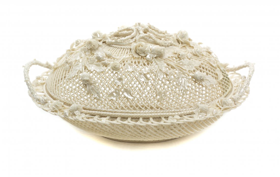 A Belleek Porcelain Covered Basket, Width 12 1/4: A Belleek Porcelain Covered Basket, of woven, oval form, having applied floral decoration and handles. Width 12 1/4 inches.