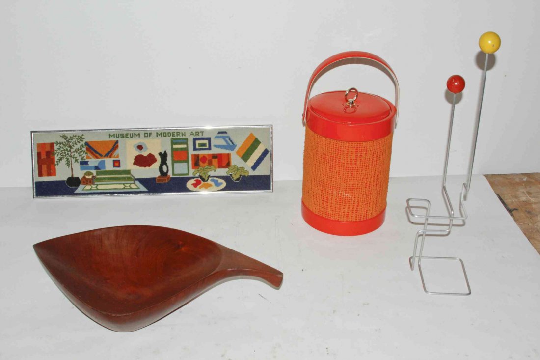 A Collection of Decorative Articles, Height of tallest: A Collection of Decorative Articles, comprising a mahogany bowl by Arthur Umanoff, an ice bucket, a framed needlepoint titled The Museum of Modern Art and a decorative table article. Height of tallest