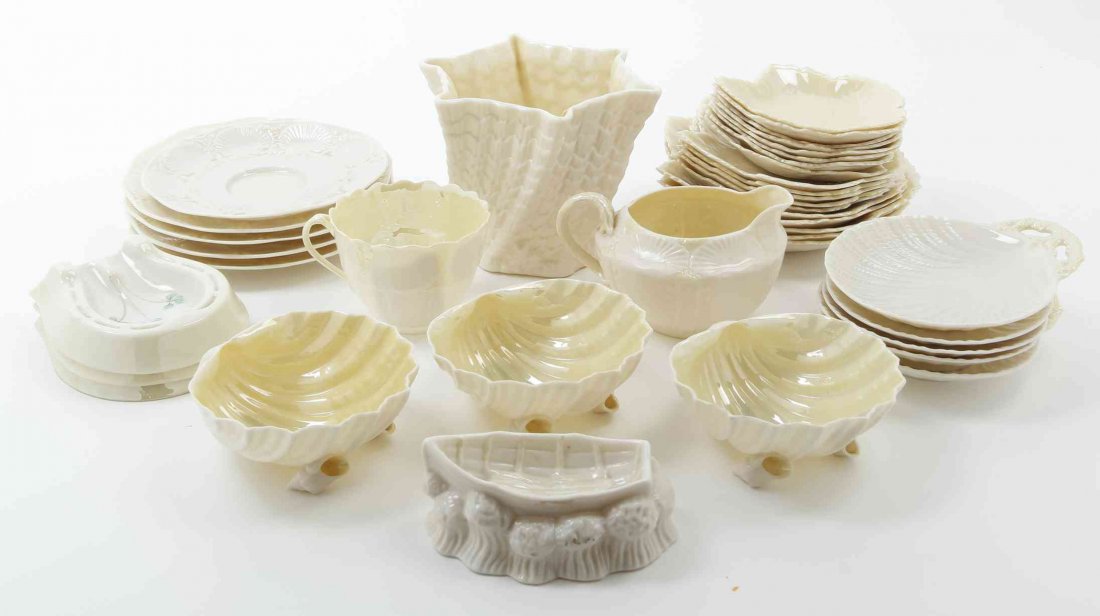 A Collection of Belleek Articles, Height of vase 4 1/4: A Collection of Belleek Articles, 1963-present, comprising a vase, a set of 3 horseshoe form ash receivers, a boat form trench salt, a set of 3 Neptune shells, a set of 18 graduated leaf form dishes, 