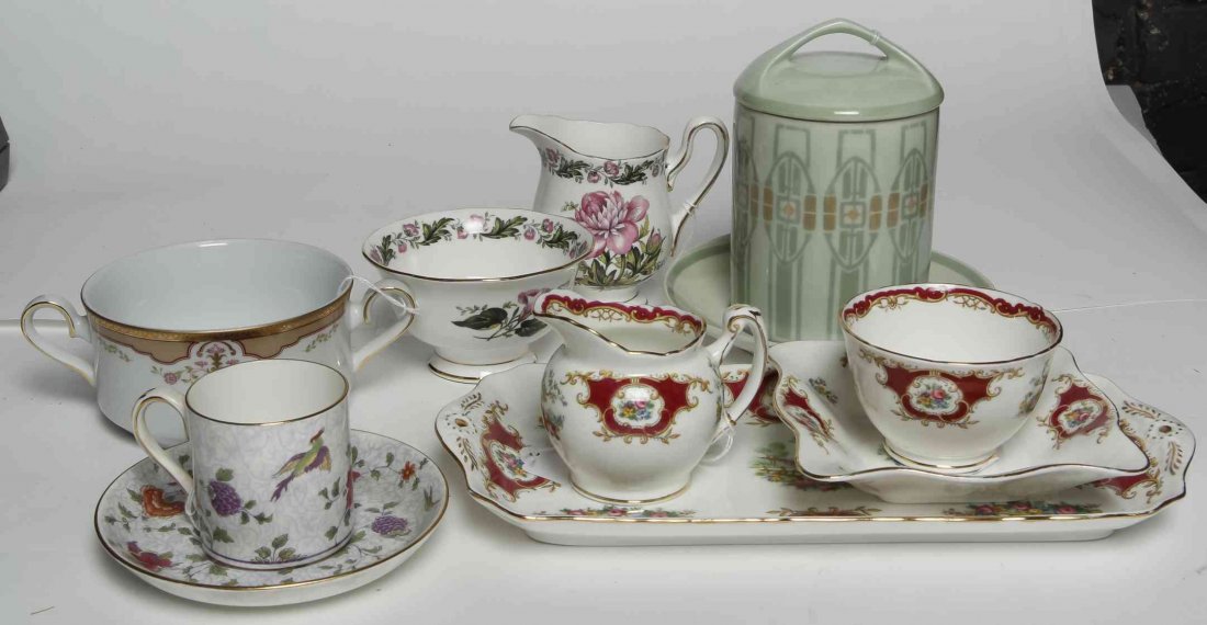 A Collection of Porcelain Table Articles, Width of: A Collection of Porcelain Table Articles, comprising a porcelain candle holder, an English creamer and sugar set, an English coffee can, an Argentinian soup bowl, and others; 11 items total. Width of 