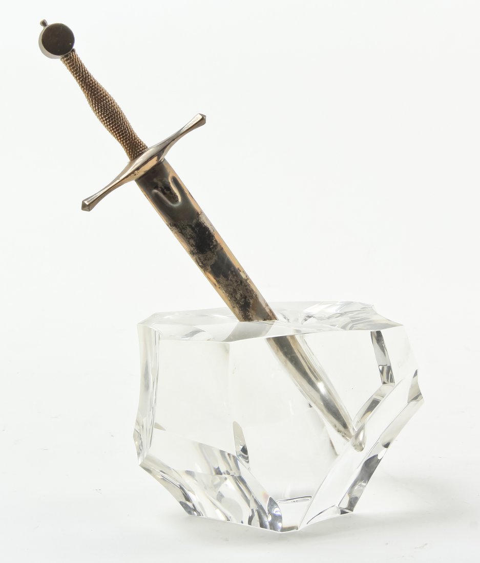A Steuben Glass and Sterling Silver Paperweight and: A Steuben Glass and Sterling Silver Paperweight and Letter Opener Set, Excalibur, designed by James Houston, model 1000, introduced in 1963, modeled as King Arthur's sword embedded in a rock. Height 8