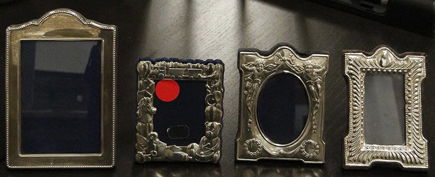 Four English Silver Photo Frames, London, 1986-1994,: Four English Silver Photo Frames, London, 1986-1994, all of shaped rectangular form with easel backs, one with beaded border, another with gadrooned border, one chased with cherubs and ribbons the las