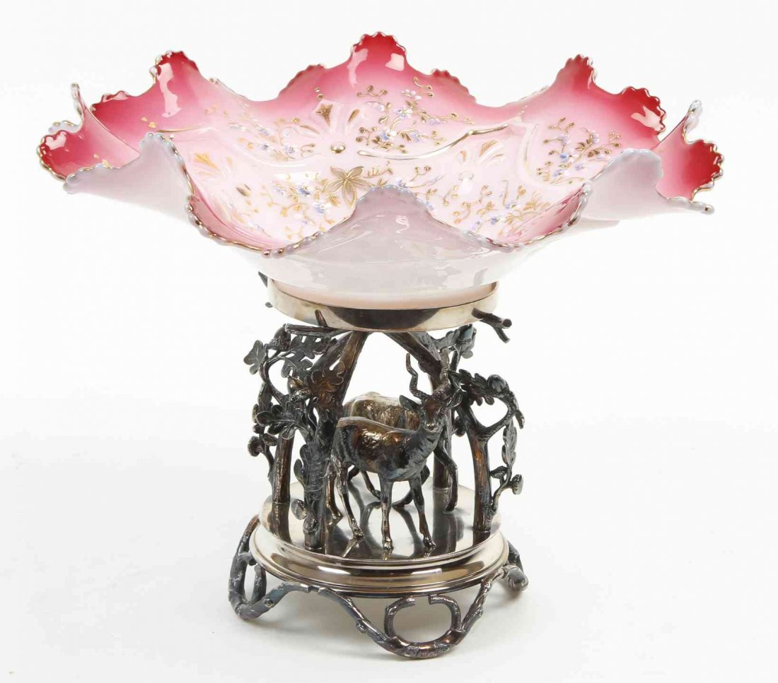 A Pairpoint Silver-Plate and Enameled Glass Bride's: A Pairpoint Silver-Plate and Enameled Glass Bride's Basket, raised on a base decorated with two gazelles amidst leafy trees. Diameter 12 1/2 inches. Property from the Collection of Ed and Dolores Herr