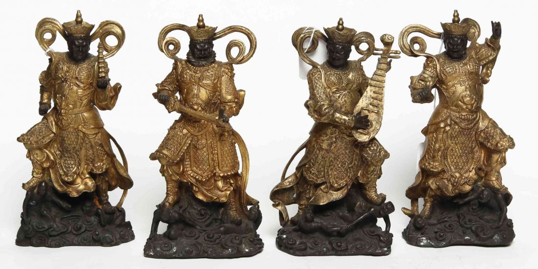 Four Gilt Decorated Bronze and Stone Deva Statues,: Four Gilt Decorated Bronze and Stone Deva Statues, three depicted with various handheld implements. Height of tallest 8 1/2 inches. Property from the Collection of Mrs. Irene Bell, Saint Augustine, Fl