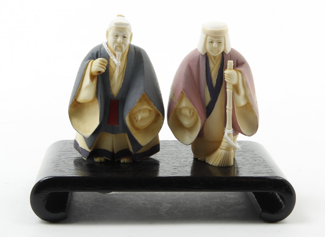 Two Japanese Carved Ivory Okimono, Height 7 3/4 inches.: Two Japanese Carved Ivory Okimono, polychrome decorated, depicting an elderly man sweeping with a broom and bucket, having tea stained accents, signed to the underside. Height 7 3/4 inches.